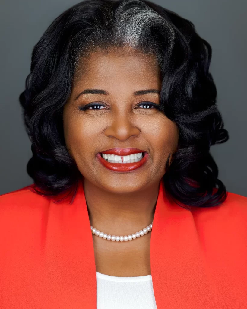 Executive director wearing a red blazer, photographed by EMS Headshots