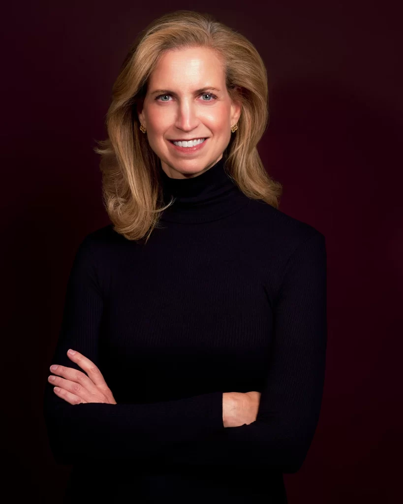 Allison wearing a black turtleneck with arms crossed in an executive portrait