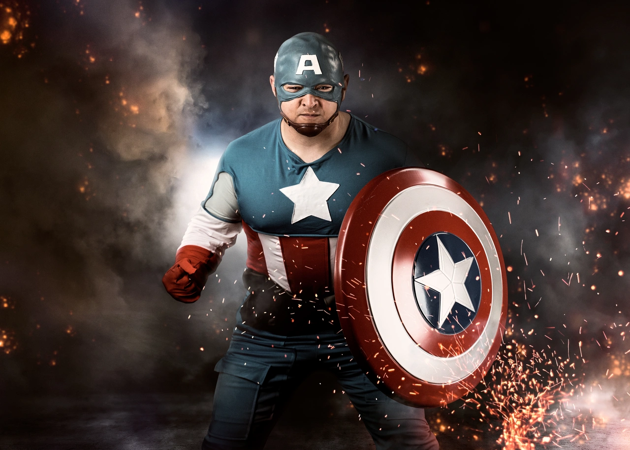 Man dressed as Captain America in a cinematic portrait with smoke, sparks, and shield.