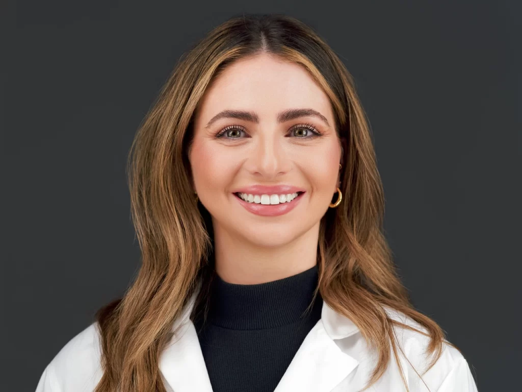 Medical headshot in San Francisco of a smiling woman wearing a white coat