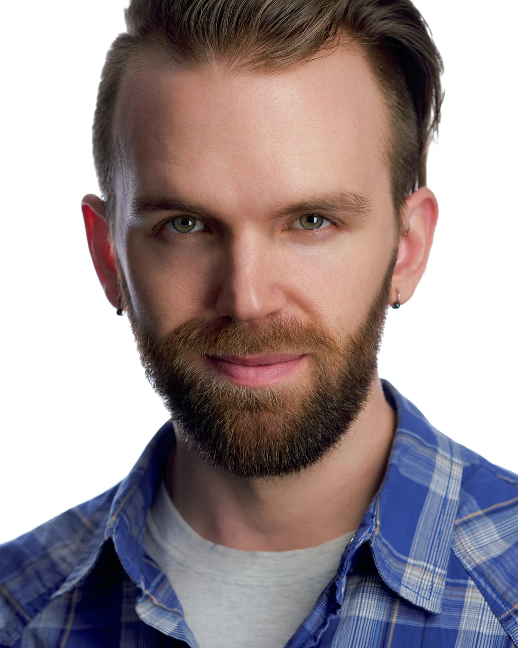 Ryan with swept-back hair and a beard wearing a blue plaid shirt against a white background.